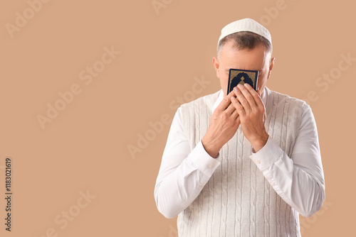 Muslim man with Koran prayi...
