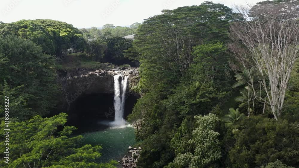 A stunning aerial perspective of Rainbow Falls on Big Island, Hawaii, nestled within a vibrant tropical rainforest and clear pool. A stunning aerial perspective of Rainbow Falls on Big Island, Hawaii, nestled within a vibrant tropical rainforest and clear pool.