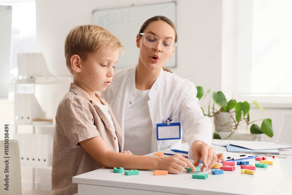 Female speech therapist working with little boy in office Female speech therapist working with little boy in office