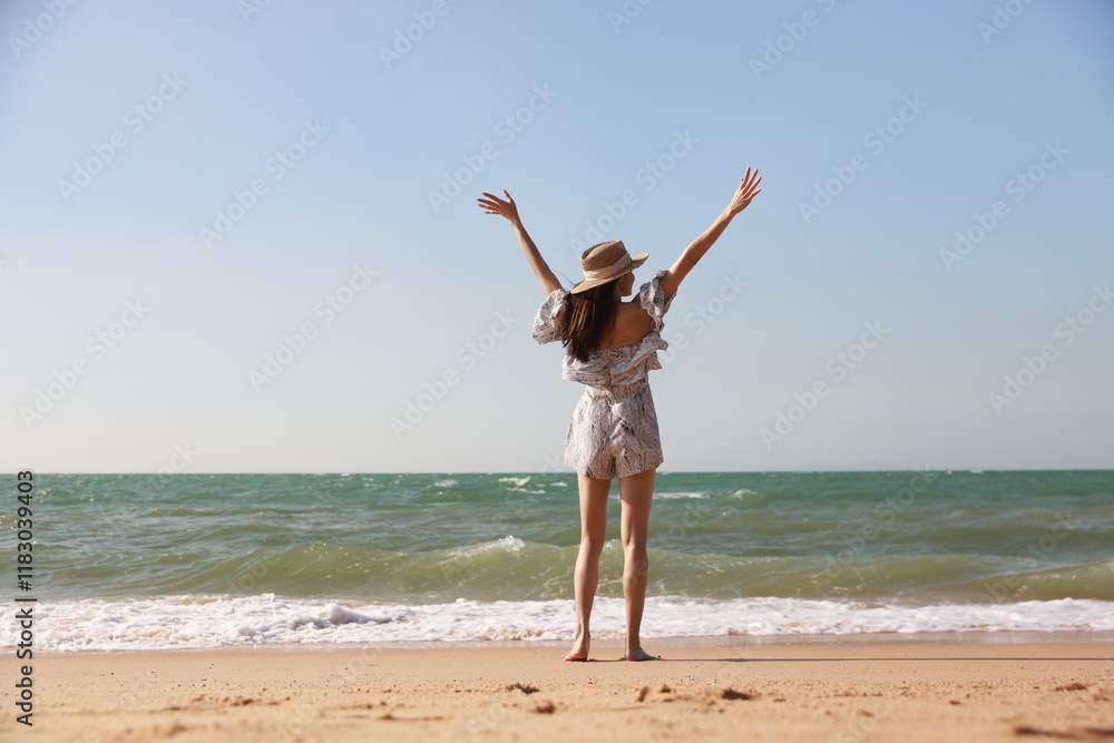 Aerial view of a happy woman on the beach.Ready for a happy sunny beach holiday
