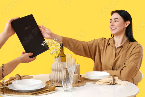Young woman taking menu fro...