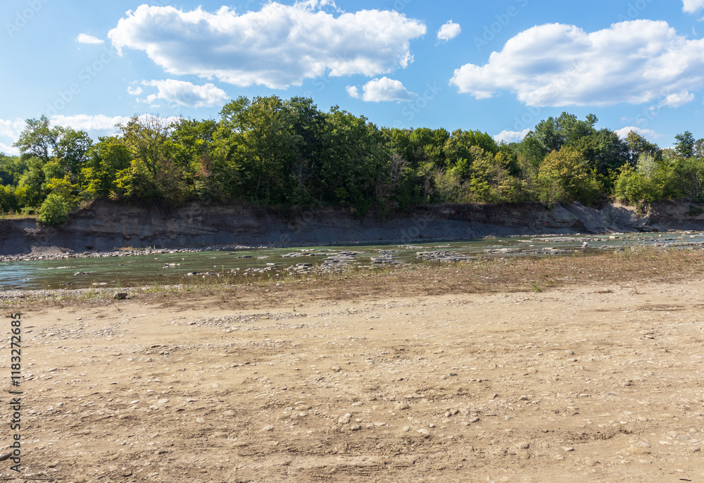It's a sunny day. shallow river in the summer, walking along the shallow riverbed It's a sunny day. shallow river in the summer, walking along the shallow riverbed