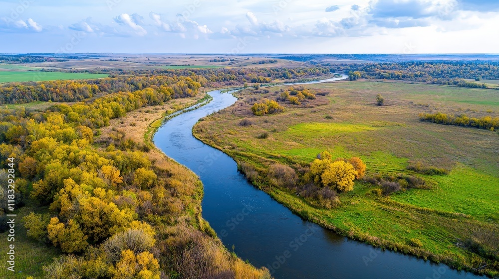Fototapeta premium High-resolution drone image of a meandering river through autumn forest vibrant colors