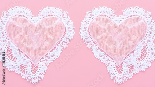 Two pink hearts adorned with white lace fabric