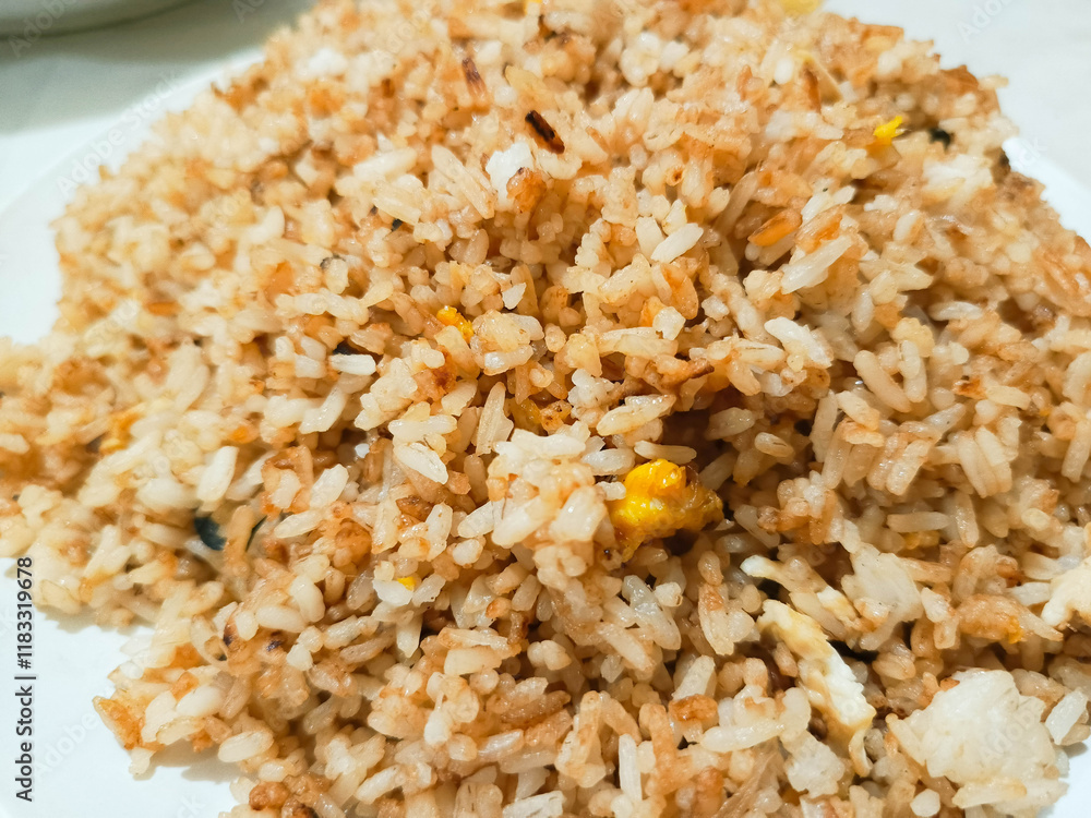 photo of mother's homemade village fried rice for breakfast placed on a white plate photo of mother's homemade village fried rice for breakfast placed on a white plate