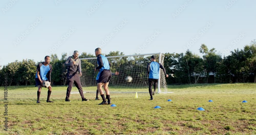 Playing soccer, athletes training on field with cones and goal in background Playing soccer, athletes training on field with cones and goal in background