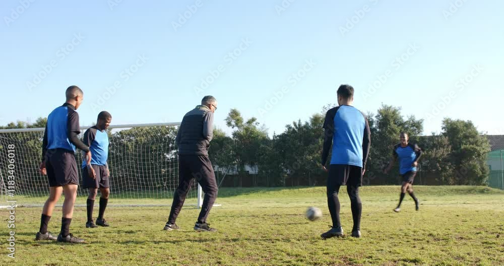 Playing soccer, team practicing on field with goal in background Playing soccer, team practicing on field with goal in background