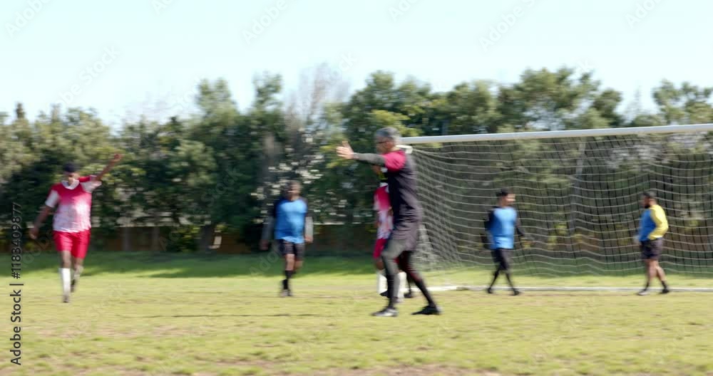 Playing soccer, team running on field towards goal during practice session Playing soccer, team running on field towards goal during practice session