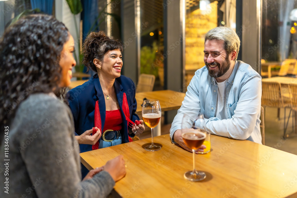Friends enjoying night talking and drinking in a bar terrace Friends enjoying night talking and drinking in a bar terrace