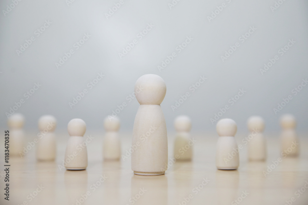 Wooden business team with one person standing out from the crowd concept for leadership or individuality Wooden business team with one person standing out from the crowd concept for leadership or individuality