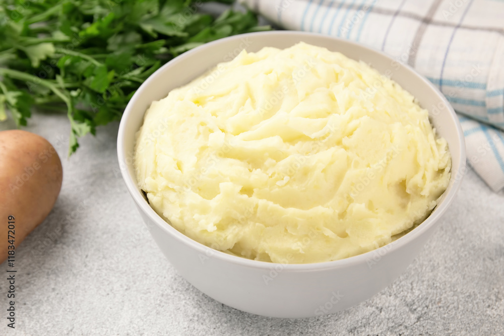 Mashed potatoes in white bowl on grey concrete background. Healthy food Mashed potatoes in white bowl on grey concrete background. Healthy food