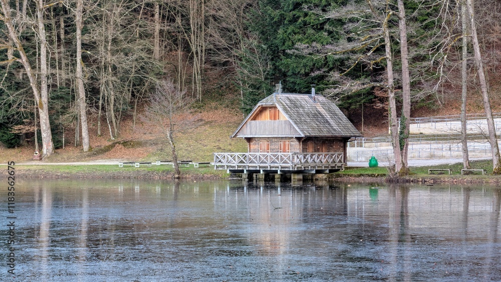 Old wooden house by the Trakoscan lake in Croatia, County Hrvatsko Zagorje, nature forest background