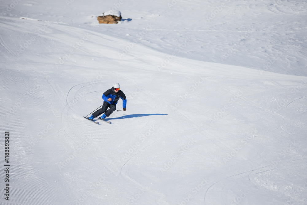 Skiing enthusiast carving turns on a pristine slope in Kitzbühel Skiing enthusiast carving turns on a pristine slope in Kitzbühel