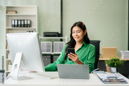 Young businesswoman working with working notepad, tablet and laptop documents talking on the smartphone, tablet photo