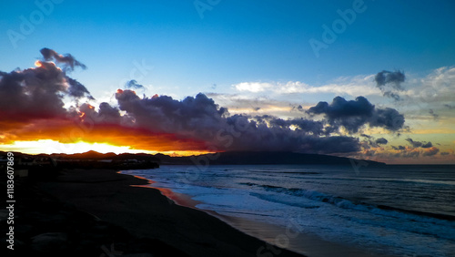 Beautiful sunset over beach in Ribiera Grande, Atlantic Ocean, Azores Islands. photo