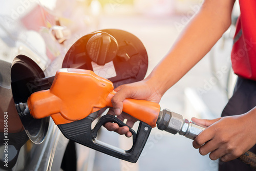 Car refueling on the petrol station. Man refilling the car with fuel. Close up view. photo