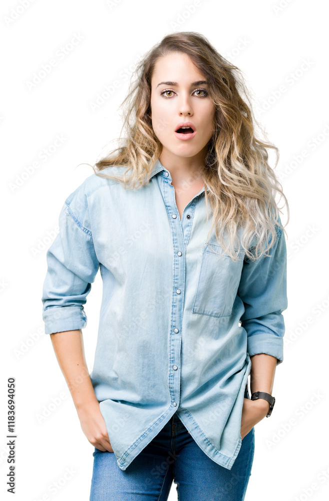 Beautiful young blonde woman over isolated background afraid and shocked with surprise expression, fear and excited face. Beautiful young blonde woman over isolated background afraid and shocked with surprise expression, fear and excited face.