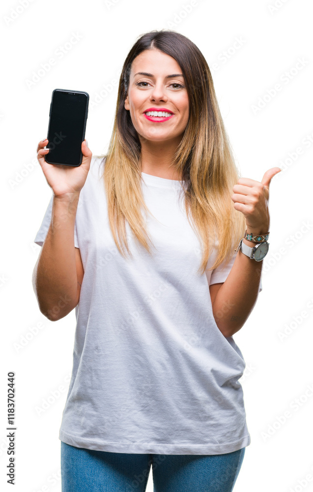 Young beautiful woman showing blank screen of smartphone over isolated background pointing and showing with thumb up to the side with happy face smiling Young beautiful woman showing blank screen of smartphone over isolated background pointing and showing with thumb up to the side with happy face smiling