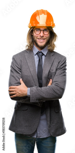 Young handsome architec man with long hair wearing safety helmet over isolated background happy face smiling with crossed arms looking at the camera. Positive person. photo