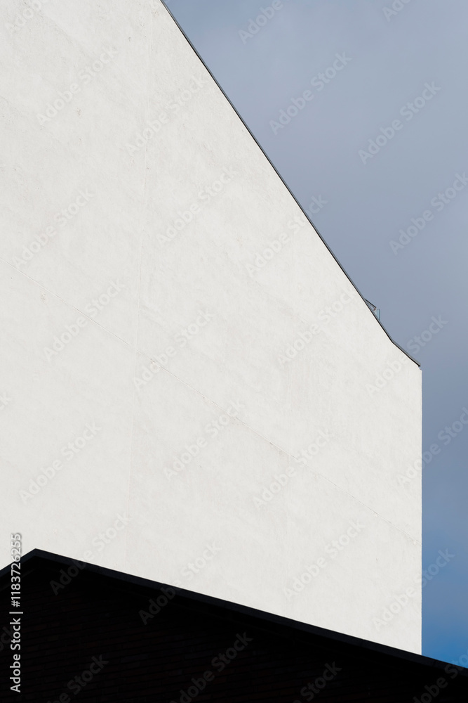 This minimalist image features a stark white architectural element set against a blue sky, exemplifying simplicity and modern design in urban settings and evoking calmness. This minimalist image features a stark white architectural element set against a blue sky, exemplifying simplicity and modern design in urban settings and evoking calmness.