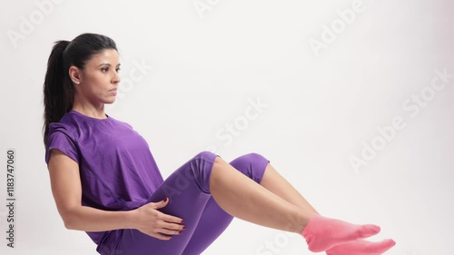 Latin woman performing slow motion pilates teaser on white background