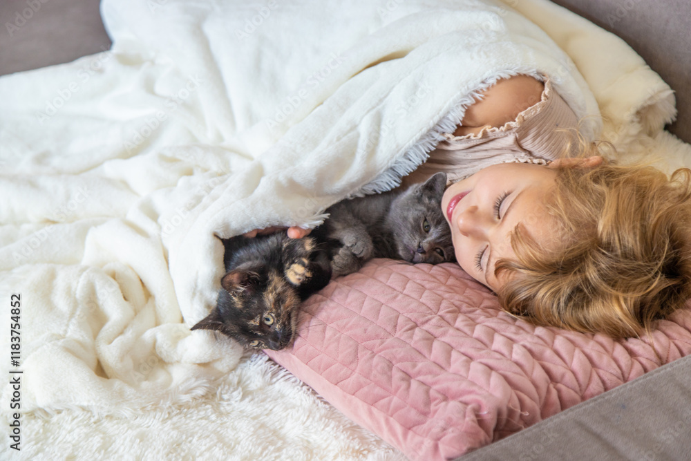 Child playing with kittens at home. Selective focus. Child playing with kittens at home. Selective focus.