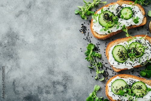 Sandwiches Salmon toast topped with cream cheese cucumber black sesame and microgreens on a gray concrete surface Seafood Nutritious meal Bird s eye view photo