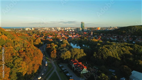 Aerial view of town. Flight over Oliwa district during the day. Forest, parks and buildings in the background. photo