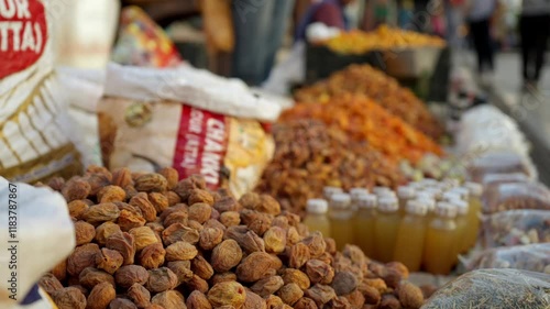 Organic sun dried apricots for sale in Leh main market street, Leh Bazaar, Ladakh, Kashmir, Closeup, slow motion with shallow depth of field and pull focus. Rich agricultural produce from India. photo