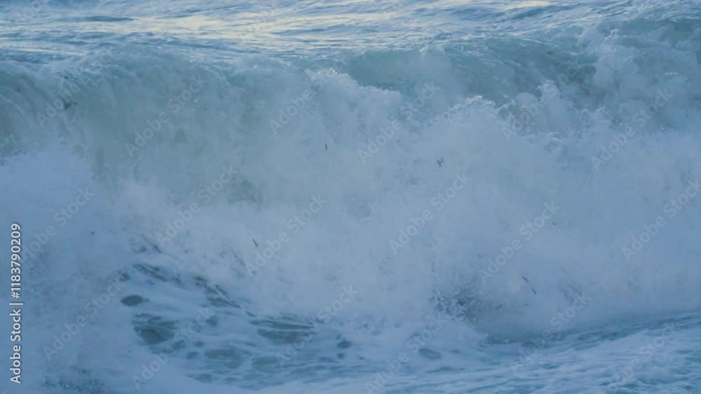 Close Up of Sea Waves Breaking onto Beach in Slow Motion with Sun Reflection on Water in Background. Rough Ocean Footage During Storm Conditions on British Bay 4K. Close Up of Sea Waves Breaking onto Beach in Slow Motion with Sun Reflection on Water in Background. Rough Ocean Footage During Storm Conditions on British Bay 4K.