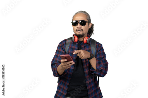 Indonesian curly haired male backpacker happy while looking at cellphone contents while traveling, travel concept, isolated on white background. photo