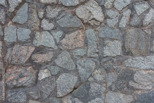 Background - wall made of gray natural shape fieldstones photo