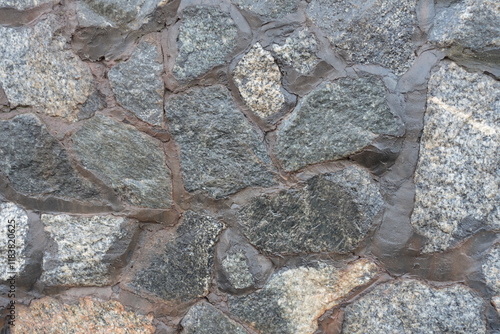 Close shot of wall made of gray natural shape fieldstones photo