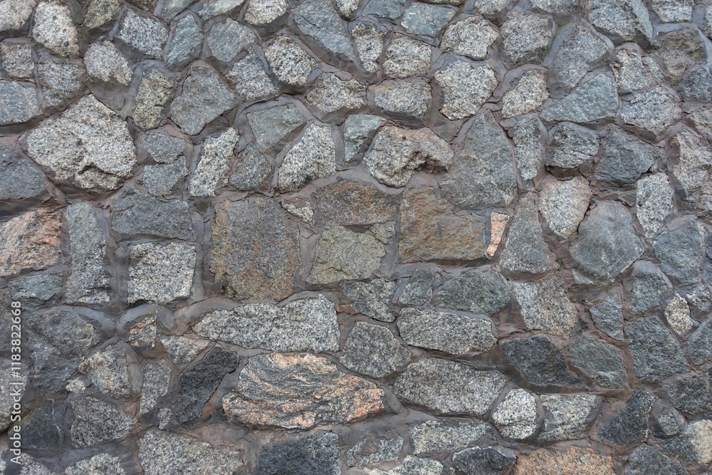 Uneven surface of wall made of gray natural shape fieldstones Uneven surface of wall made of gray natural shape fieldstones