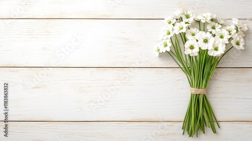 Wallpaper Mural A fresh bouquet of white flowers tied with natural twine, resting on a rustic wooden surface, conveying beauty and simplicity. Torontodigital.ca