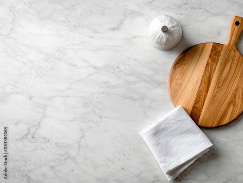 Aerial view of a marble countertop displaying a wooden chopping board and neatly folded linen napkin