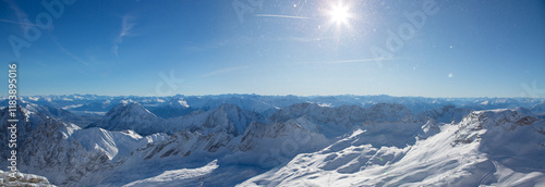 Panoramic view of beautiful winter mountain scenery in the Alps in sun light.