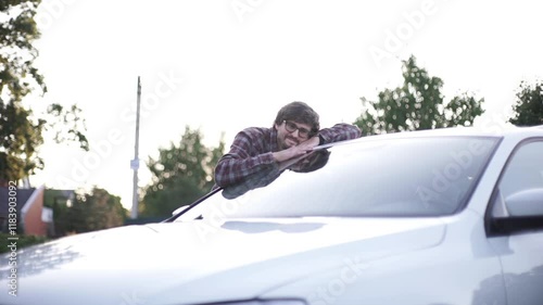 Happy man hugging his new car