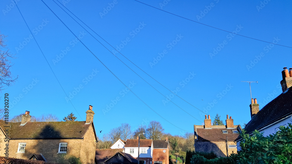 Fototapeta premium Aerial view of English countryside village with charming tiled rooftops.
