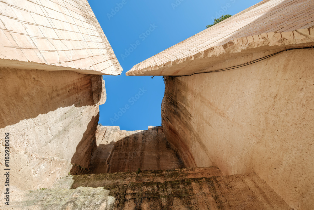 A stunning view of the intricate stone carvings and structures at Lithica sandstone quarries, vacation spot, Famous quarry near the town of Ciutadella, Minorca, Spain.