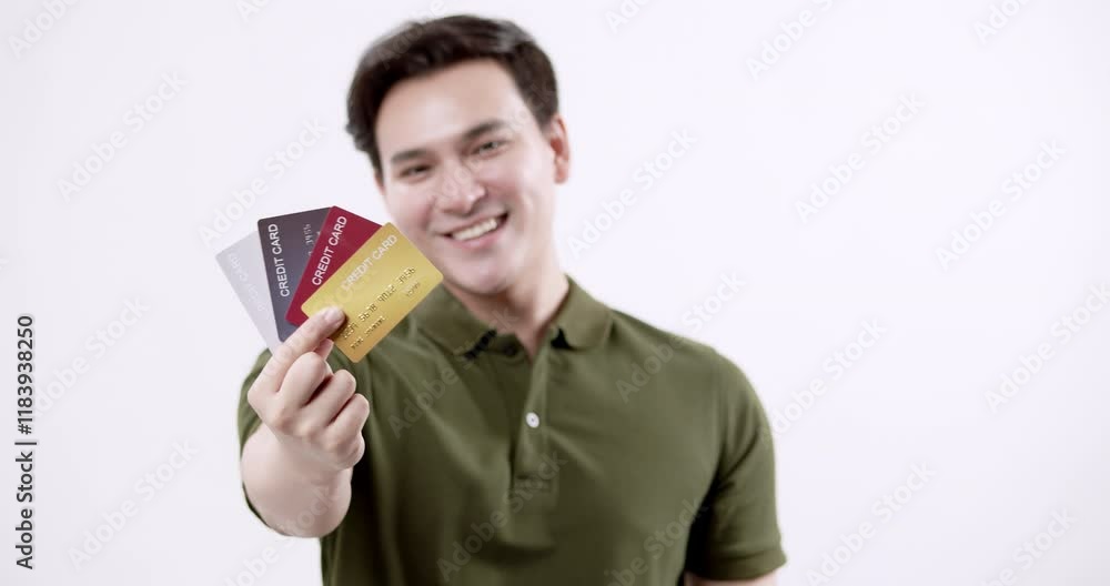 A man displays his credit cards highlighting financial options and benefits in a professional environment. A man displays his credit cards highlighting financial options and benefits in a professional environment.