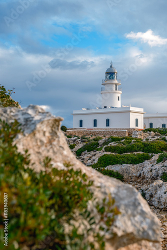 Obraz na płótnie View from the rocks off the coast of the Cap de Cavalleria lighthouse on the north coast of Menorca (Balearic Islands) during a summer day with dramatic cloudy sky, Minorca, Spain. w salonie