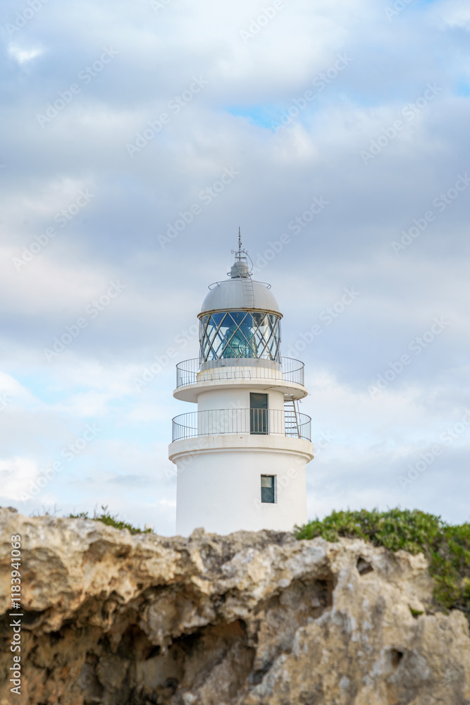 View from the top of the lighthouse of Cap de Cavalleria on the north coast of Menorca (Balearic Islands) during a summer day with dramatic cloudy sky, Minorca, Spain View from the top of the lighthouse of Cap de Cavalleria on the north coast of Menorca (Balearic Islands) during a summer day with dramatic cloudy sky, Minorca, Spain
