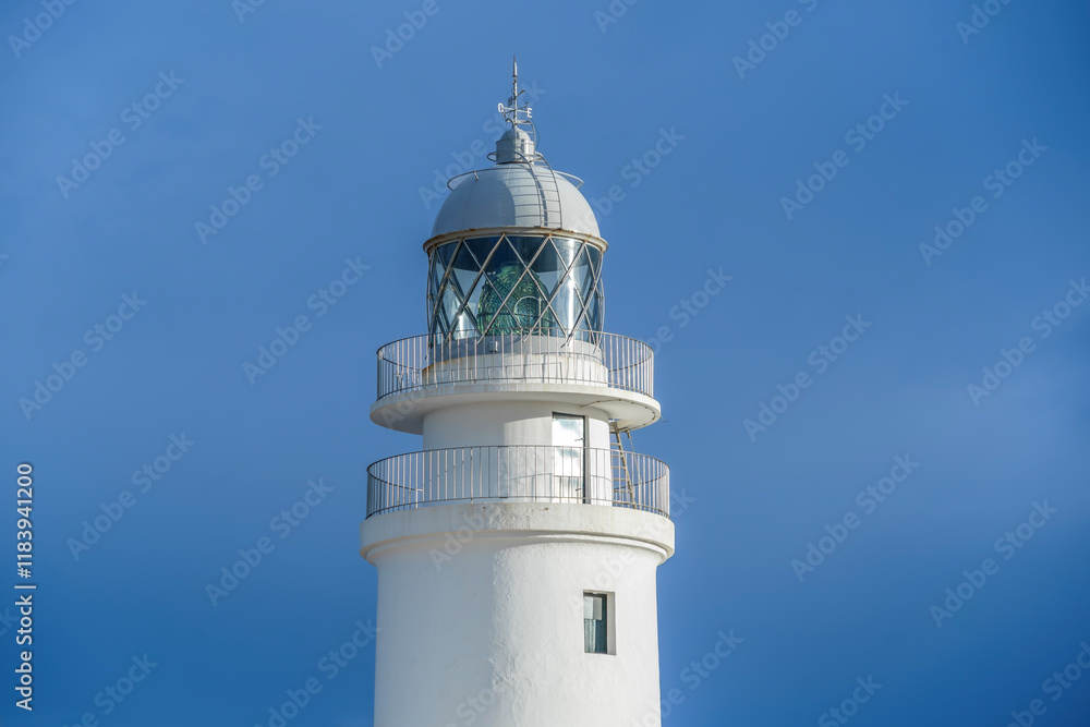 View from the top of the lighthouse of Cap de Cavalleria on the north coast of Menorca (Balearic Islands) during a summer day with dramatic cloudy sky, Minorca, Spain