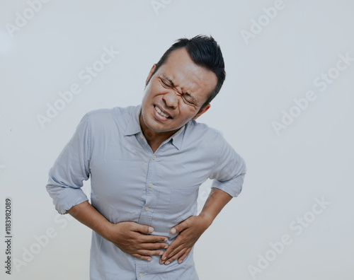 Asian man got bad stomach ache, isolated on white background. photo