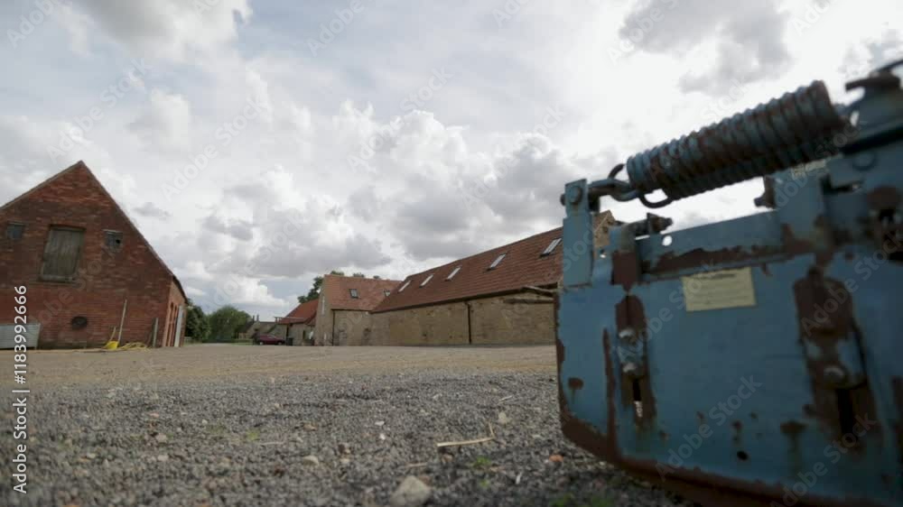 Tracking Shot Across Abandoned Blue Rusted Machinery in Gravel Farmyard Tracking Shot Across Abandoned Blue Rusted Machinery in Gravel Farmyard