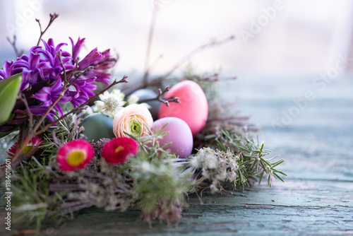 Wall Mural Easter eggs decorated with colorful spring flowers on old rustic wood surface