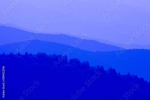 A blue sky with mountains in the background