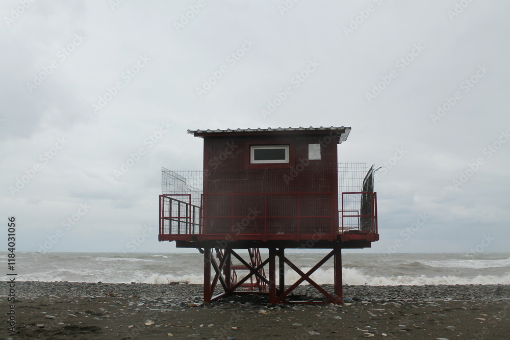 Empty lifeguard tower on the beach during a storm