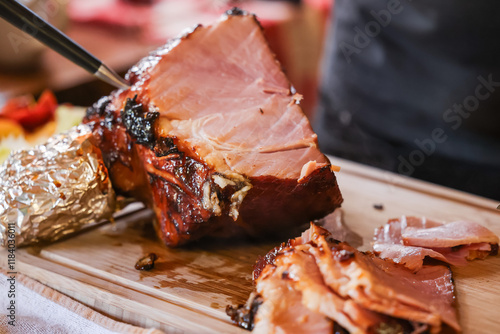 Glazed Christmas ham on kitchen bench carved and ready for serving